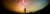 A person in the distance looking up to the starry night sky