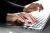 woman's hand typing on a laptop keyboard