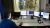 Man in front of four computer screens