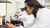 Chemist looking through microscope 